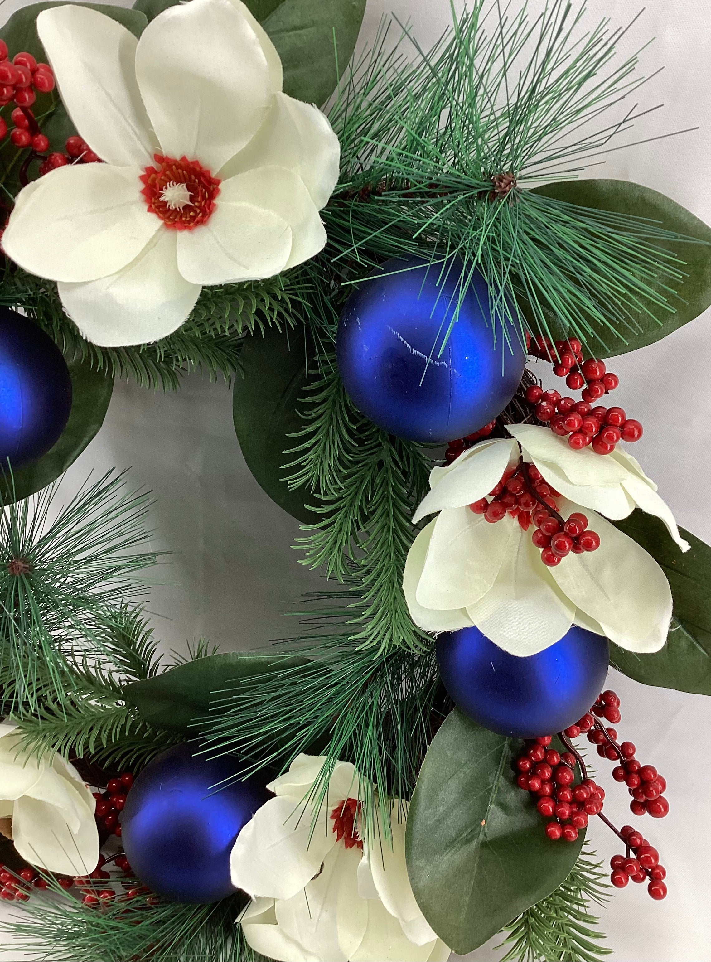20” diameter Decorated  Wreath with blue shatterproof, white floral, berries